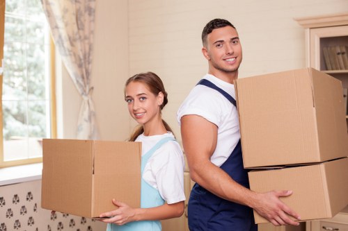 Worker wearing PPE while moving items in a storage environment